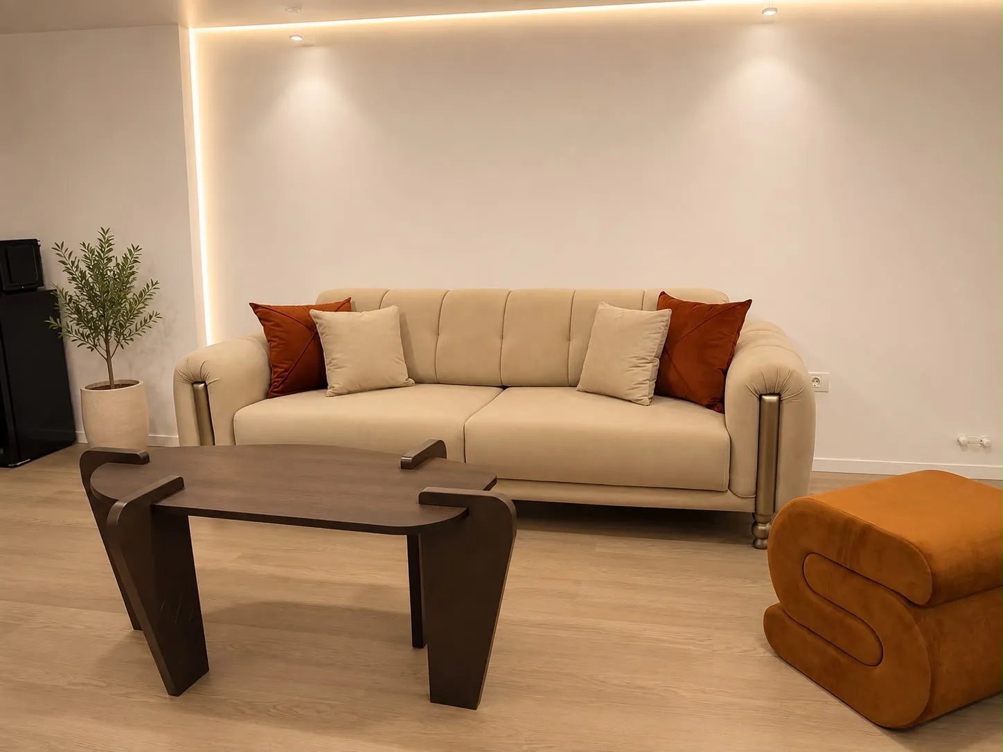Living room in the evening, lit by warm cove lighting